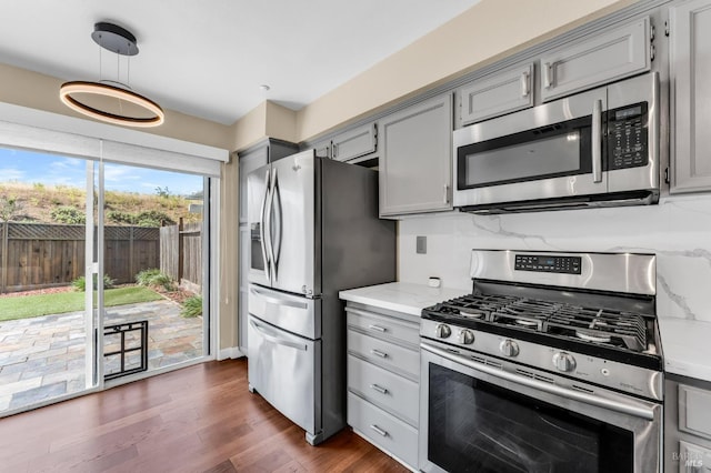 247 Clearpointe Dr, Vallejo, CA 94591 - kitchen featuring stainless steel appliances, gray cabinetry, dark wood-type flooring, hanging light fixtures, and decorative backsplash