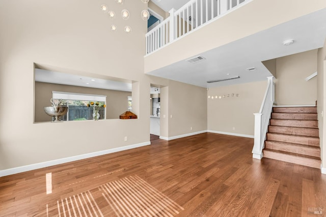 247 Clearpointe Dr, Vallejo, CA 94591 - unfurnished living room featuring wood finished floors, stairs, and baseboards