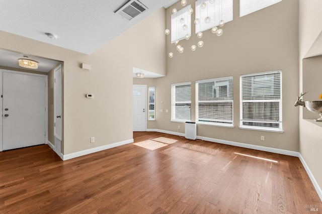 247 Clearpointe Dr, Vallejo, CA 94591 - unfurnished living room with high vaulted ceiling, wood finished floors, and baseboards