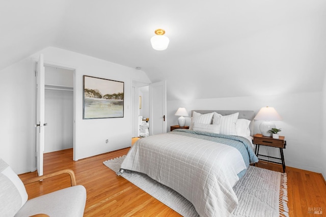 1186 E Ave, Napa, CA 94559 - bedroom with vaulted ceiling, light wood-style flooring, a walk in closet, and a closet