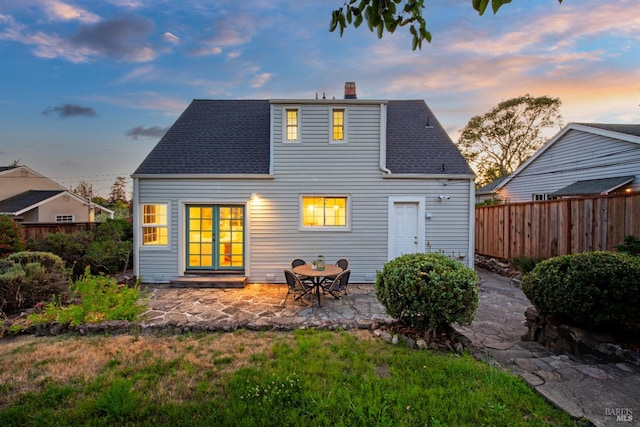 1186 E Ave, Napa, CA 94559 - back of property at dusk with a chimney, a patio area, and roof with shingles