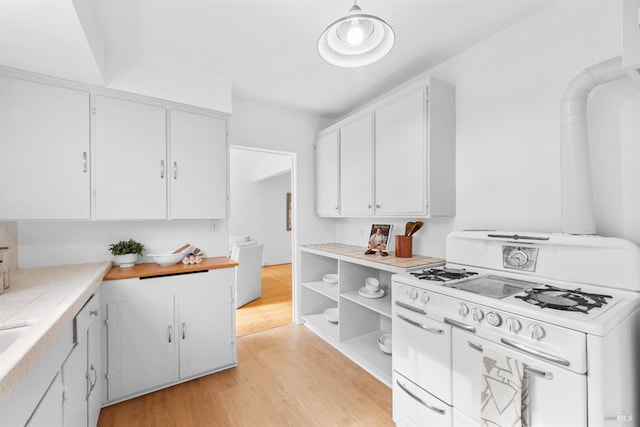 1186 E Ave, Napa, CA 94559 - kitchen with double oven range, white cabinetry, light countertops, light wood-style floors, and open shelves