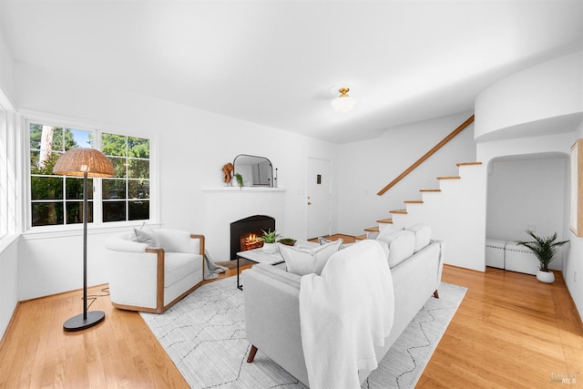 1186 E Ave, Napa, CA 94559 - living room featuring wood finished floors, a lit fireplace, and stairs
