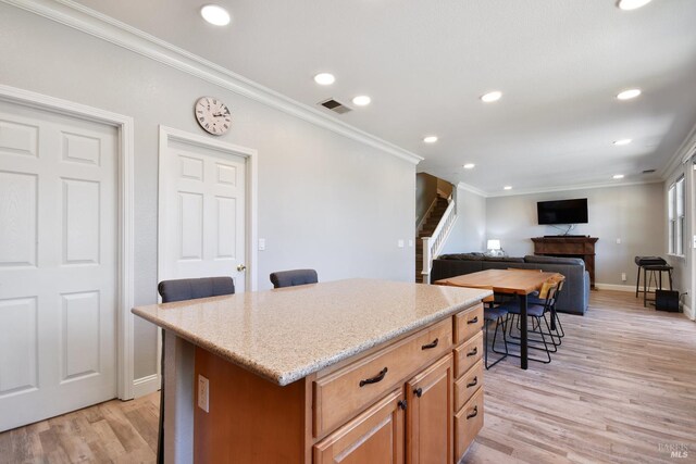712 Tahoe Ct, Fairfield, CA 94534 - kitchen featuring ornamental molding, recessed lighting, light wood-style floors, baseboards, and a center island