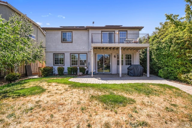 712 Tahoe Ct, Fairfield, CA 94534 - back of house with a patio area, solar panels, stucco siding, and a balcony