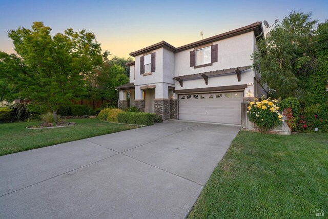 712 Tahoe Ct, Fairfield, CA 94534 - view of front of home with driveway, an attached garage, stone siding, a front yard, and stucco siding