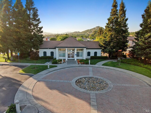 712 Tahoe Ct, Fairfield, CA 94534 - view of front of house featuring a mountain view, french doors, a tiled roof, curved driveway, and stucco siding