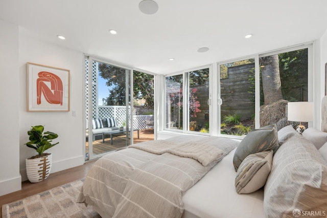 56 Aztec St, San Francisco, CA 94110 - bedroom with access to outside, wood finished floors, recessed lighting, expansive windows, and baseboards