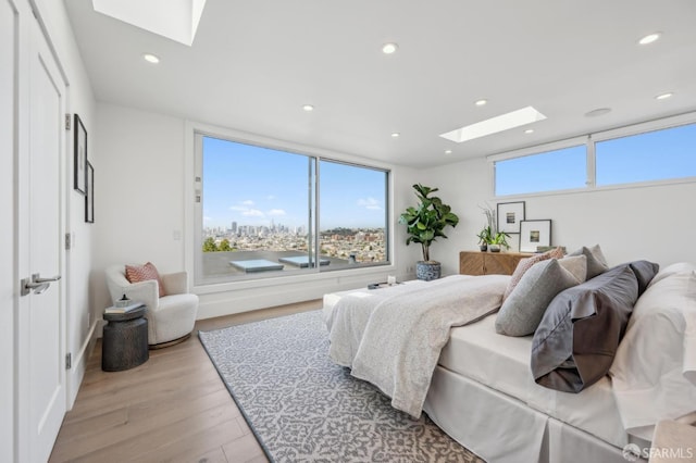 56 Aztec St, San Francisco, CA 94110 - bedroom featuring a skylight, light wood-style floors, recessed lighting, and access to exterior