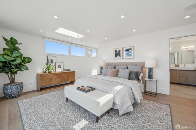 56 Aztec St, San Francisco, CA 94110 - bedroom featuring a skylight, light wood finished floors, baseboards, recessed lighting, and ensuite bath