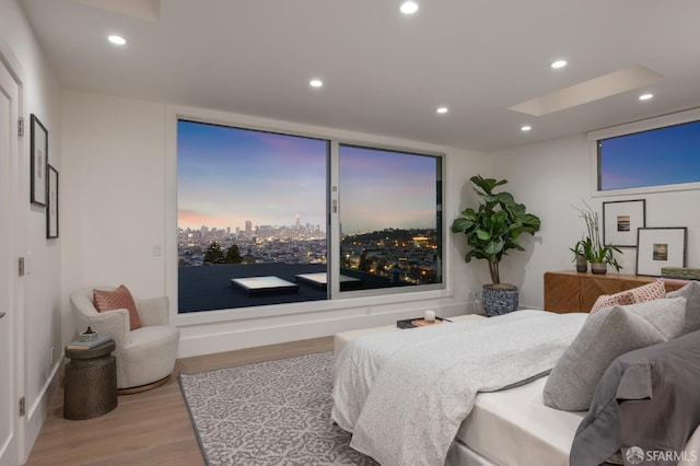 56 Aztec St, San Francisco, CA 94110 - bedroom with wood finished floors, recessed lighting, a skylight, and a view of city