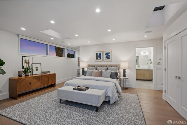 56 Aztec St, San Francisco, CA 94110 - bedroom featuring light wood-style flooring, recessed lighting, connected bathroom, and baseboards
