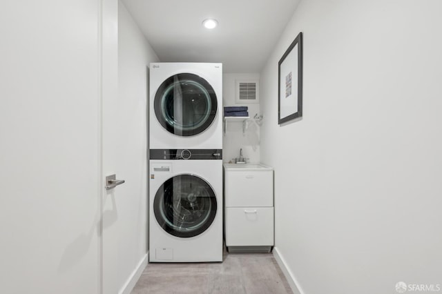 56 Aztec St, San Francisco, CA 94110 - laundry area featuring stacked washer / drying machine, baseboards, and recessed lighting