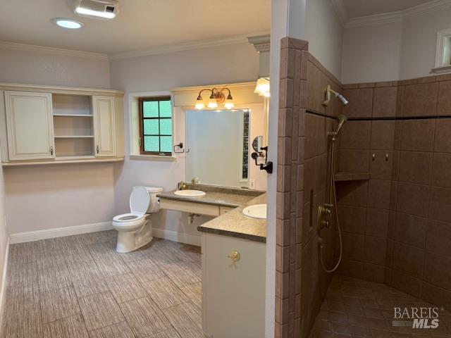 350 N Barnes St, Ukiah, CA 95482 - bathroom featuring tiled shower, vanity, toilet, baseboards, and ornamental molding