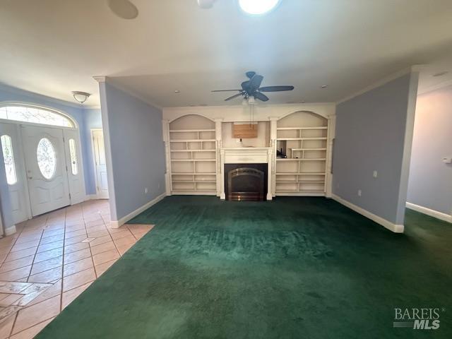 350 N Barnes St, Ukiah, CA 95482 - unfurnished living room featuring ornamental molding, ceiling fan, baseboards, tile patterned flooring, and a fireplace