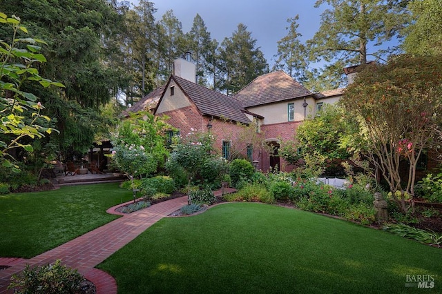 3850 Montecito Ave, Santa Rosa, CA 95404 - view of front of property featuring a front yard, a chimney, brick siding, and stucco siding