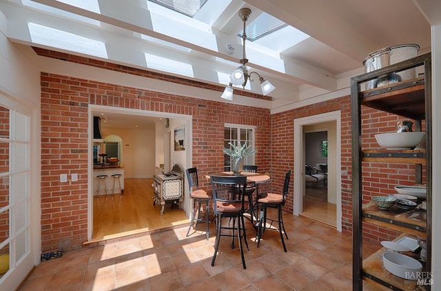 3850 Montecito Ave, Santa Rosa, CA 95404 - dining area featuring a skylight, brick wall, and light tile patterned floors