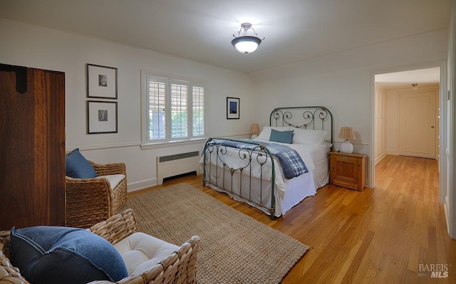 3850 Montecito Ave, Santa Rosa, CA 95404 - bedroom featuring radiator heating unit, light wood-style floors, and baseboards