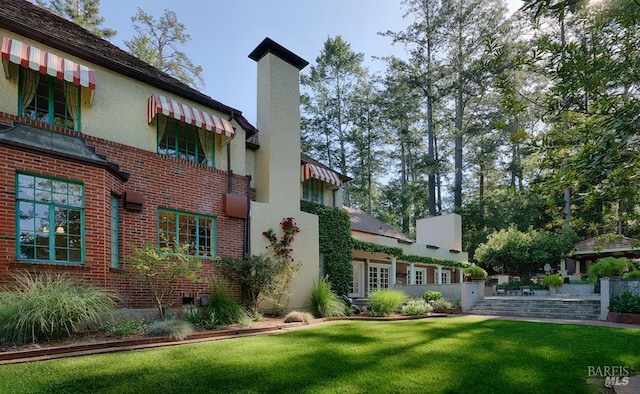 3850 Montecito Ave, Santa Rosa, CA 95404 - view of property exterior with a chimney, brick siding, and a lawn