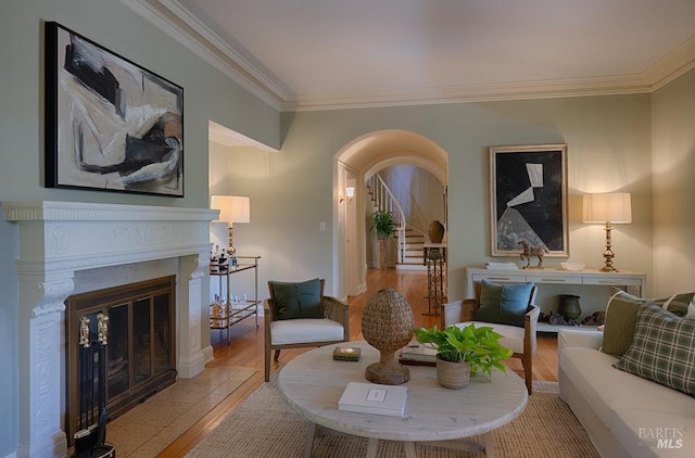 3850 Montecito Ave, Santa Rosa, CA 95404 - living area featuring ornamental molding, light wood-type flooring, a glass covered fireplace, and arched walkways