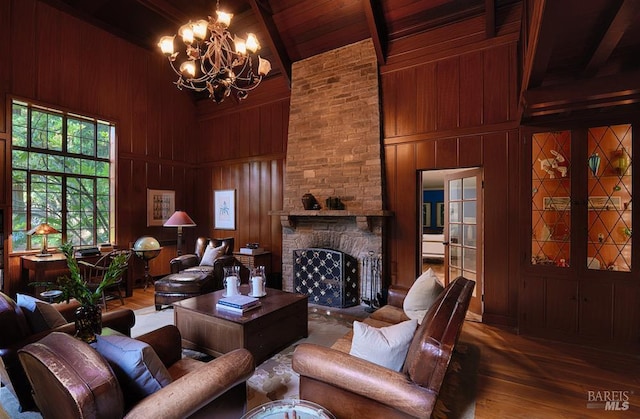 3850 Montecito Ave, Santa Rosa, CA 95404 - living area with high vaulted ceiling, wooden walls, a chandelier, wood finished floors, and a stone fireplace