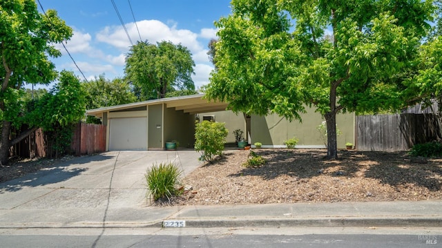 2235 Juniperberry Dr, San Rafael, CA 94903 - view of front of home featuring stucco siding, concrete driveway, and a garage