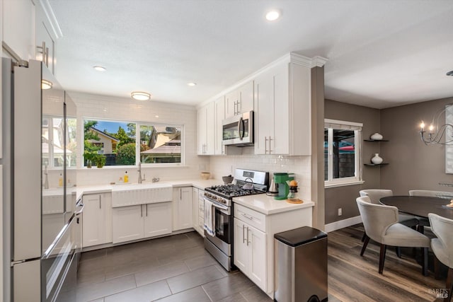 4260 Plass Dr, Napa, CA 94558 - kitchen with stainless steel appliances, a sink, decorative backsplash, light countertops, and white cabinets