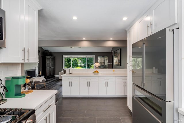 4260 Plass Dr, Napa, CA 94558 - kitchen with high end refrigerator, light countertops, white cabinets, backsplash, and open floor plan