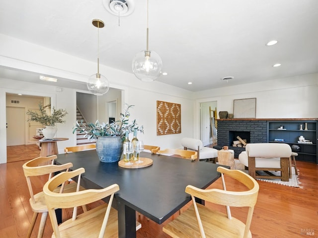9 Park St, San Rafael, CA 94901 - dining room featuring stairs, wood finished floors, recessed lighting, and a brick fireplace