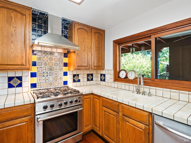 1010 Easum Dr, Napa, CA 94558 - kitchen with stainless steel stove, wall chimney exhaust hood, dishwashing machine, a sink, and tasteful backsplash