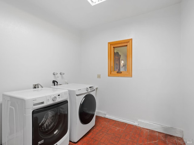 1010 Easum Dr, Napa, CA 94558 - laundry area featuring washer and dryer, brick patterned floors, and baseboards