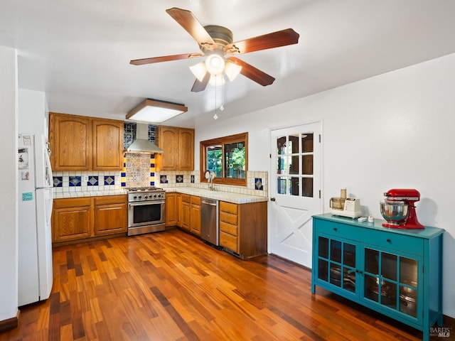 1010 Easum Dr, Napa, CA 94558 - kitchen featuring appliances with stainless steel finishes, brown cabinets, light countertops, and wall chimney exhaust hood