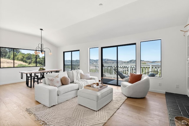 34 Laurel Dr, Corte Madera, CA 94925 - living area featuring vaulted ceiling, a chandelier, light wood-type flooring, and baseboards