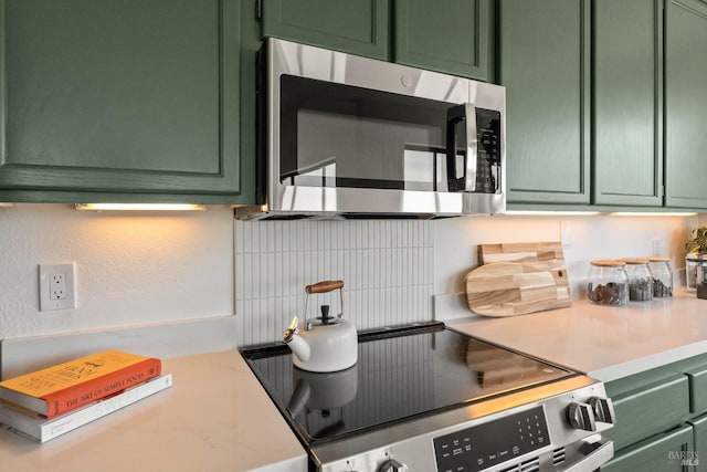 34 Laurel Dr, Corte Madera, CA 94925 - kitchen featuring green cabinets, appliances with stainless steel finishes, decorative backsplash, and light countertops
