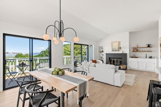34 Laurel Dr, Corte Madera, CA 94925 - dining area with vaulted ceiling, light wood finished floors, built in shelves, a brick fireplace, and a water view