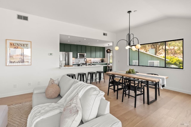 34 Laurel Dr, Corte Madera, CA 94925 - living area featuring healthy amount of natural light, baseboards, light wood finished floors, a chandelier, and vaulted ceiling