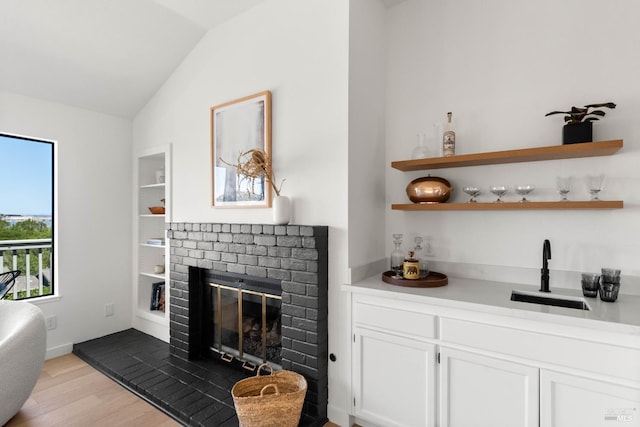 34 Laurel Dr, Corte Madera, CA 94925 - indoor bar with vaulted ceiling, a fireplace, light wood-style floors, built in features, and baseboards