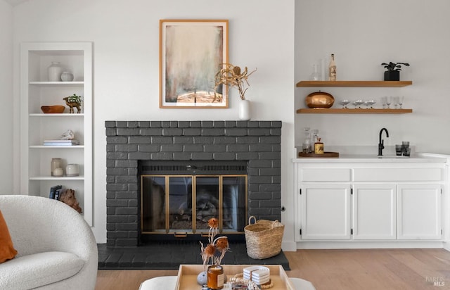 34 Laurel Dr, Corte Madera, CA 94925 - living area featuring light wood finished floors, a brick fireplace, built in features, and wet bar