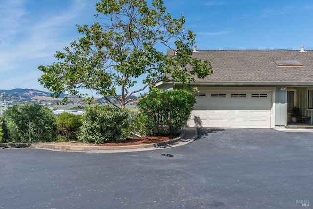 34 Laurel Dr, Corte Madera, CA 94925 - view of side of home with driveway, a garage, and a shingled roof
