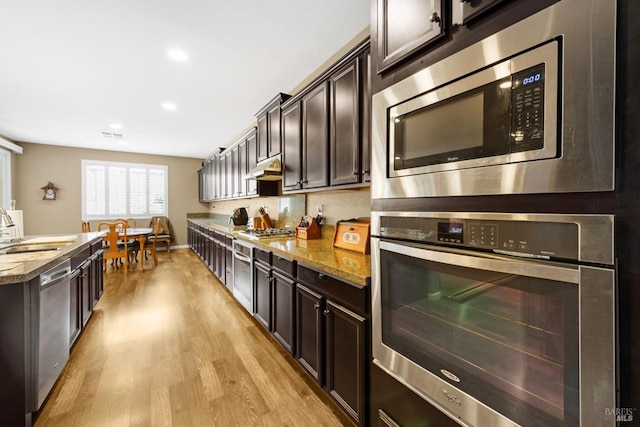 2234 Pullen Ln, Fairfield, CA 94533 - kitchen with appliances with stainless steel finishes, a sink, light wood-type flooring, dark brown cabinets, and recessed lighting