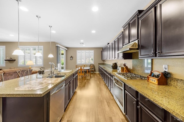 2234 Pullen Ln, Fairfield, CA 94533 - kitchen with stainless steel appliances, under cabinet range hood, light wood finished floors, a sink, and dark brown cabinetry