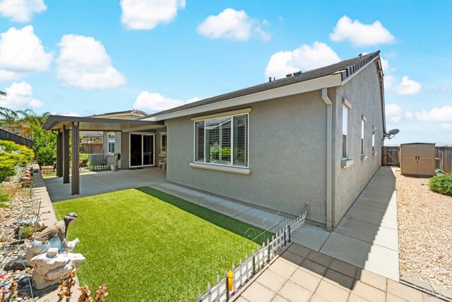 2234 Pullen Ln, Fairfield, CA 94533 - back of property featuring a patio area, stucco siding, and a storage unit