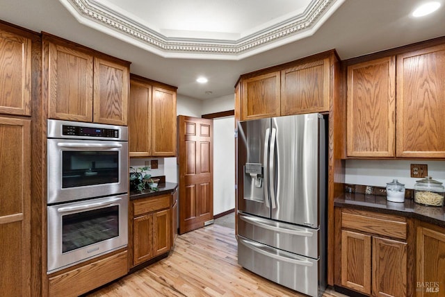 192 Carson Rd, Woodacre, CA 94973 - kitchen with appliances with stainless steel finishes, brown cabinetry, dark countertops, light wood-type flooring, and recessed lighting