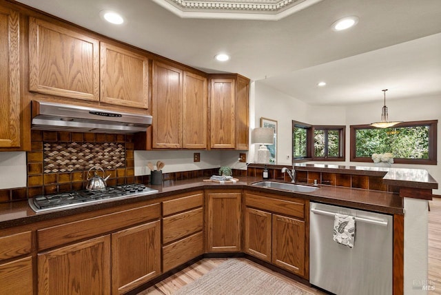 192 Carson Rd, Woodacre, CA 94973 - kitchen featuring appliances with stainless steel finishes, a sink, under cabinet range hood, a peninsula, and brown cabinets