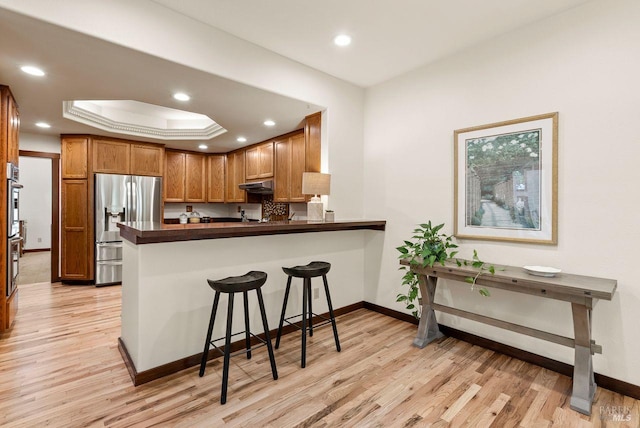 192 Carson Rd, Woodacre, CA 94973 - kitchen featuring appliances with stainless steel finishes, baseboards, under cabinet range hood, light wood-style floors, and recessed lighting