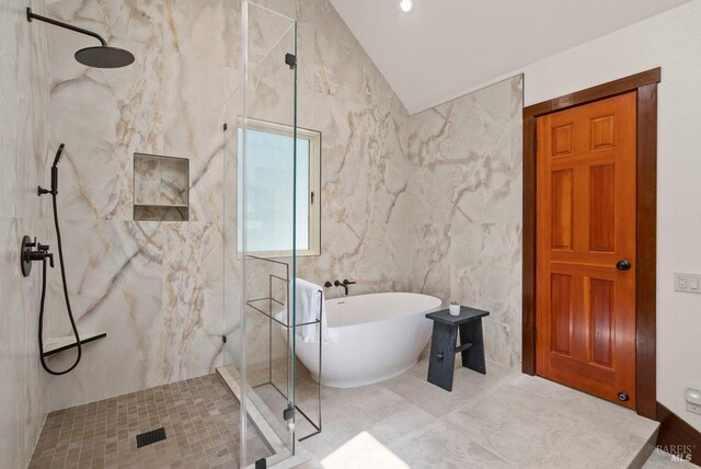 192 Carson Rd, Woodacre, CA 94973 - bathroom featuring a marble finish shower, a soaking tub, vaulted ceiling, and tile walls