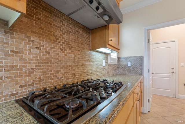508 Riverwood Ln, Rio Vista, CA 94571 - kitchen featuring gas cooktop, under cabinet range hood, light tile patterned floors, light stone countertops, and ornamental molding