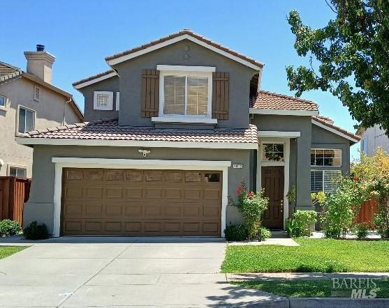 2813 Rockridge Dr, Fairfield, CA 94534 - mediterranean / spanish-style house featuring a tile roof, driveway, stucco siding, and a garage