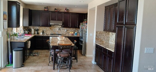 2813 Rockridge Dr, Fairfield, CA 94534 - kitchen featuring extractor fan, dark brown cabinetry, backsplash, stainless steel appliances, and a sink