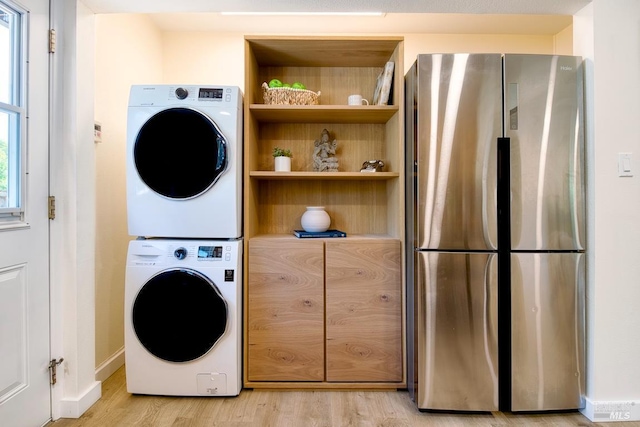 3051 Edison St, Graton, CA 95444 - laundry area featuring stacked washer and clothes dryer, light wood-style floors, and baseboards